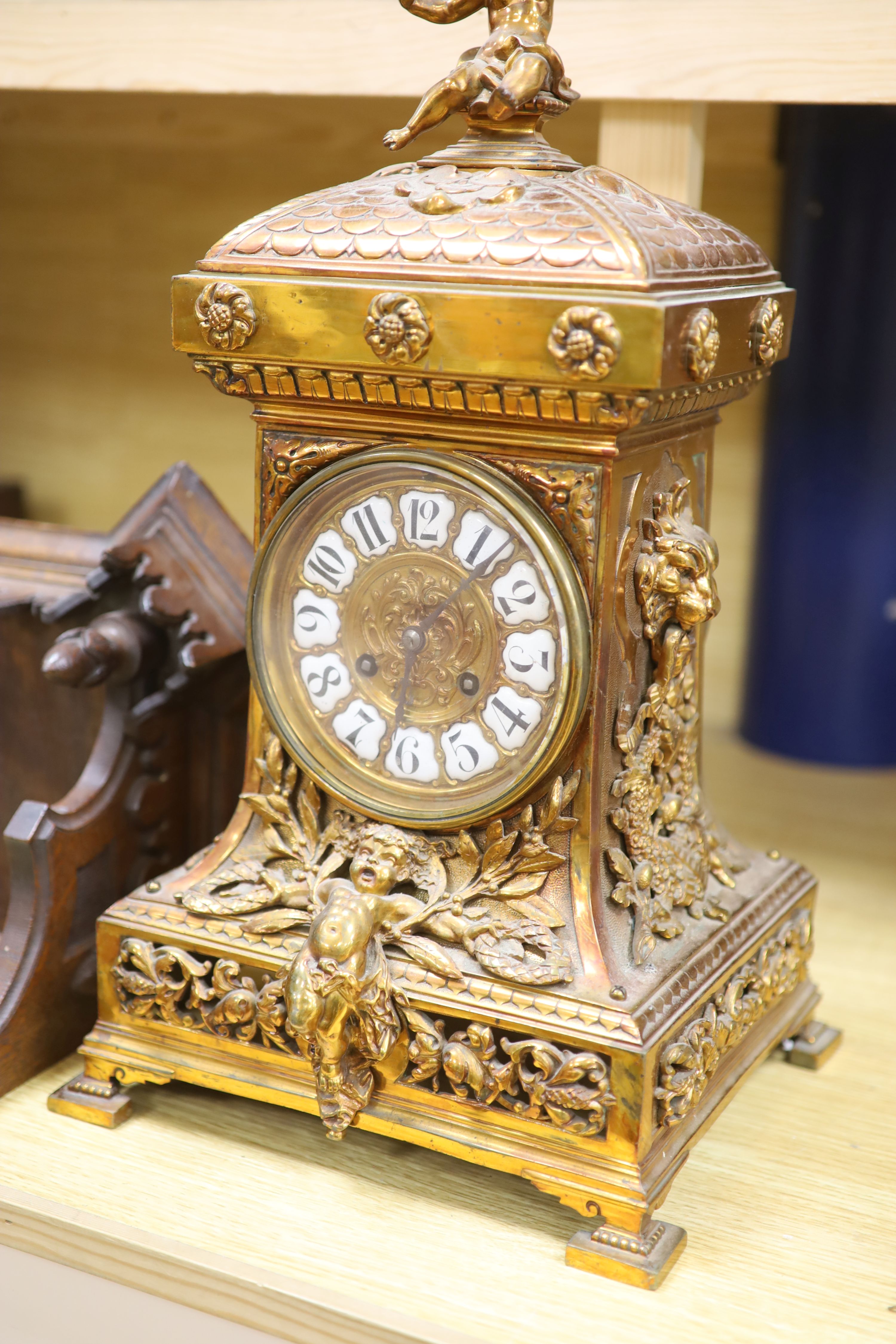 A late 19th century French cast brass cased eight day mantel clock and a carved oak clock bracket, height 50cm